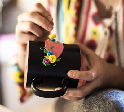 Embedding flowers on the blue cup. High quality photo